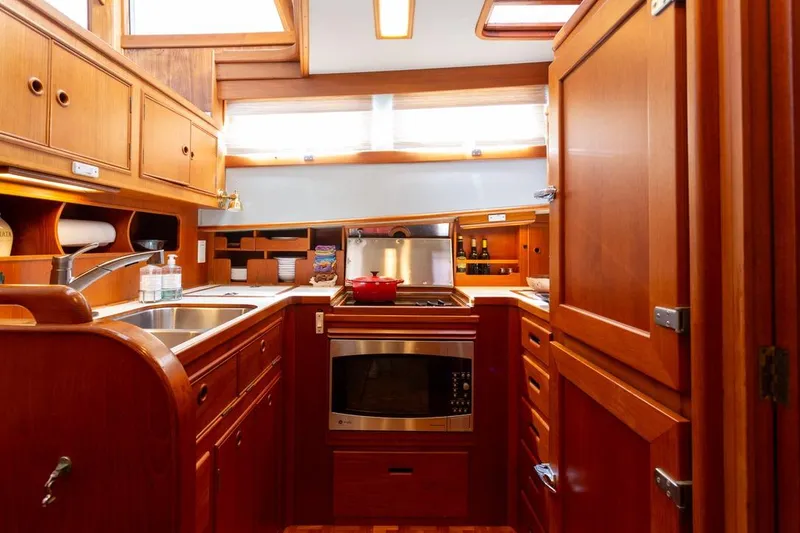 Slide: The Image of 1993 Grand Banks 46 Motoryacht kitchen with wooden cabinetry and modern appliances. - 51