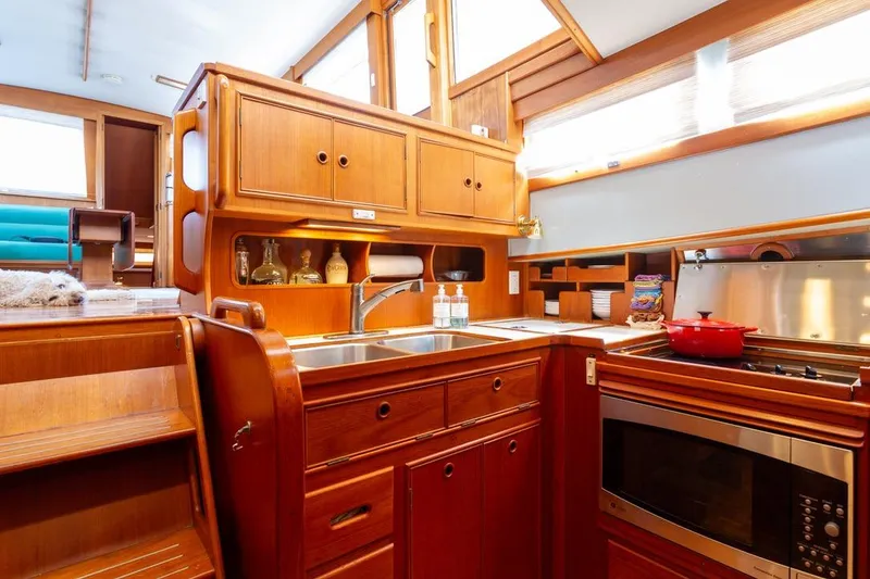 Slide: The Image of Bathroom interior of 1993 Grand Banks 46 Motoryacht, featuring wood cabinetry and natural light. - 52