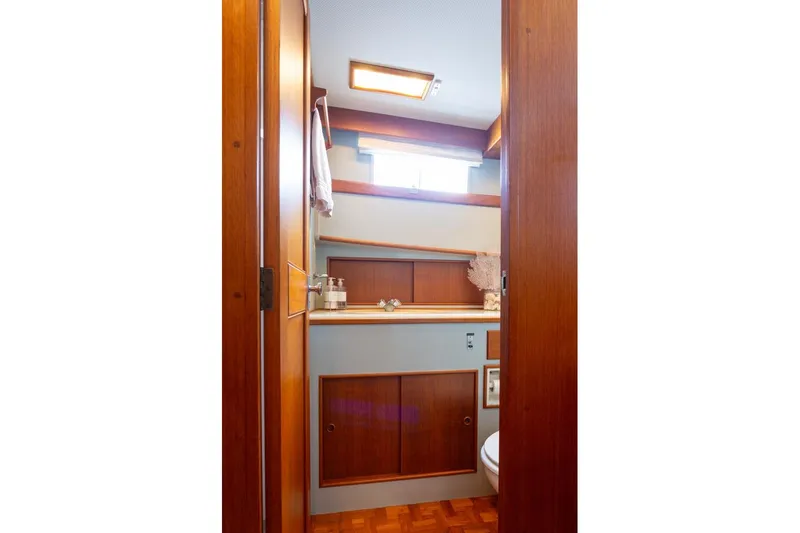 Slide: The Image of 1993 Grand Banks 46 Motoryacht bathroom with wood accents and modern fixtures. - 53