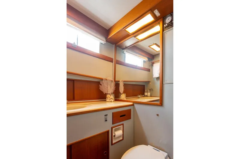 Slide: The Image of Shower area in 1993 Grand Banks 46 Motoryacht with wooden accents and towel rack. - 54