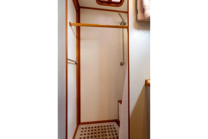 Slide: The Image of 1993 Grand Banks 46 Motoryacht interior with wooden helm, seating, and navigation equipment. - 55