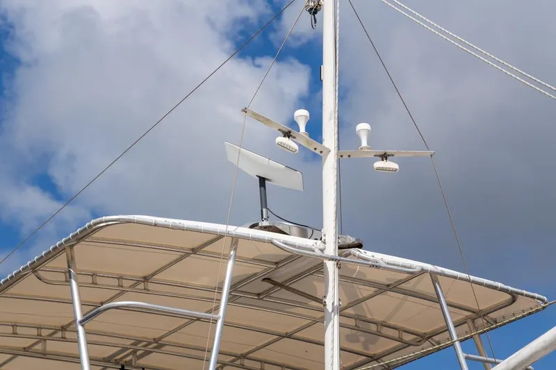 Slide: The Image of 1993 Grand Banks 46 Motoryacht with radar and antennas against a cloudy sky. - 6