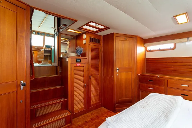 Slide: The Image of Luxurious cabin interior of 1993 Grand Banks 46 Motoryacht with wooden furnishings and cozy bedding. - 66