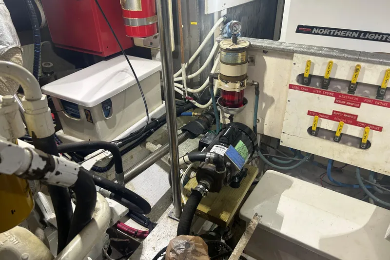 Slide: The Image of Engine room of 1993 Grand Banks 46 Motoryacht with fuel system components and control panel. - 70