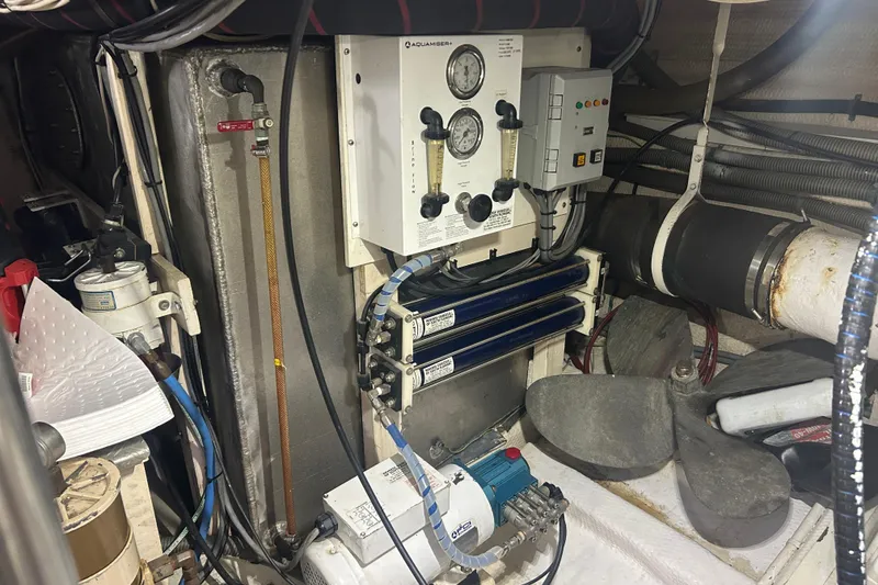 Slide: The Image of Engine room of 1993 Grand Banks 46 Motoryacht with mechanical equipment and gauges. - 74