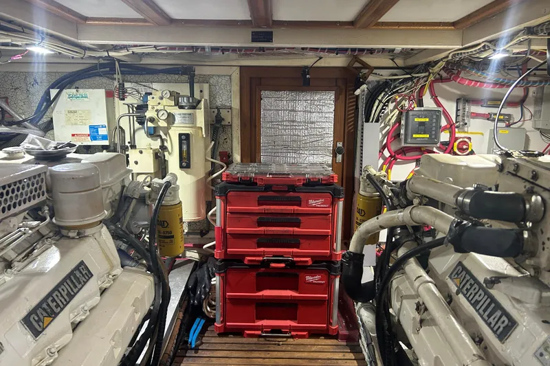 Slide: The Image of Engine room of 1993 Grand Banks 46 Motoryacht with Caterpillar engines and organized tool storage. - 77