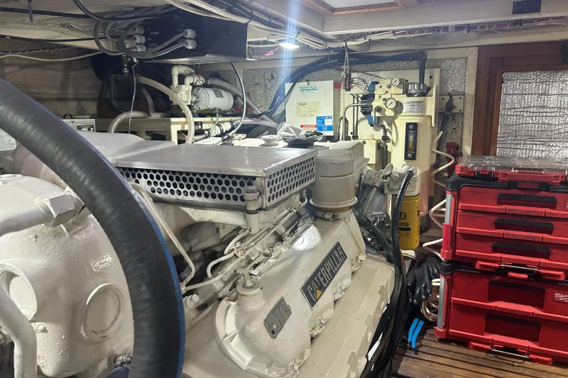 Slide: The Image of Engine room of a 1993 Grand Banks 46 Motoryacht with Caterpillar engine and tool storage. - 78