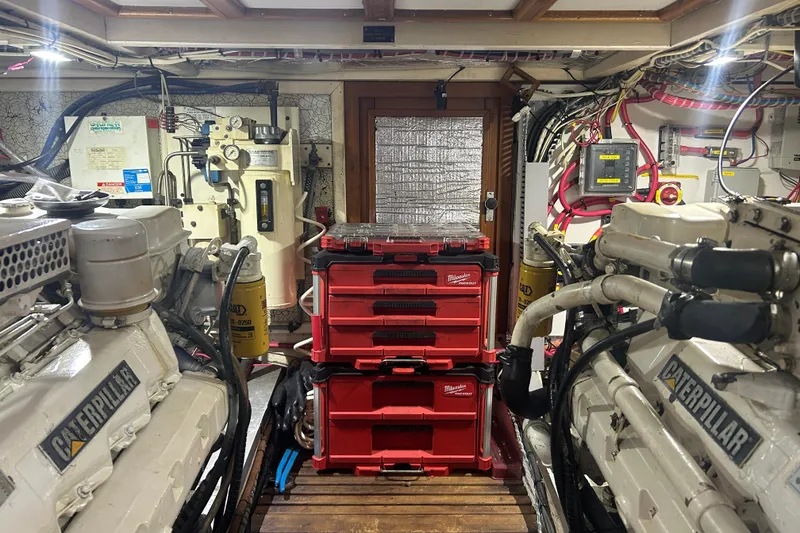 Slide: The Image of Engine room of 1993 Grand Banks 46 Motoryacht with Caterpillar engines and organized tool storage. - 79