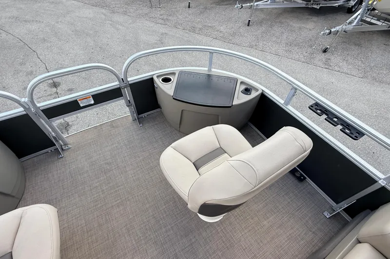 Slide: The Image of 2022 Sun Tracker Fishin' Barge 22 DLX interior with seating and fishing station. - 14