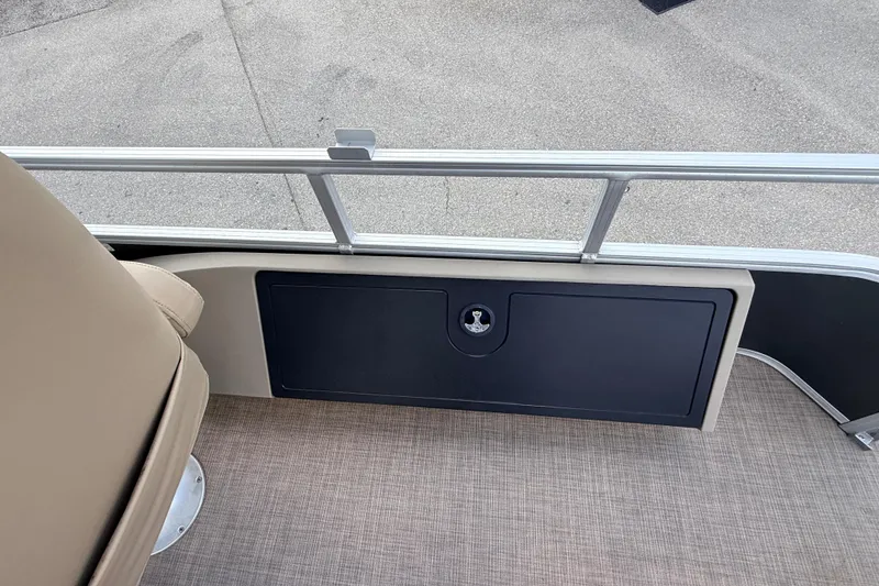 Slide: The Image of 2022 Sun Tracker Fishin' Barge 22 DLX interior with seating and storage compartment. - 22