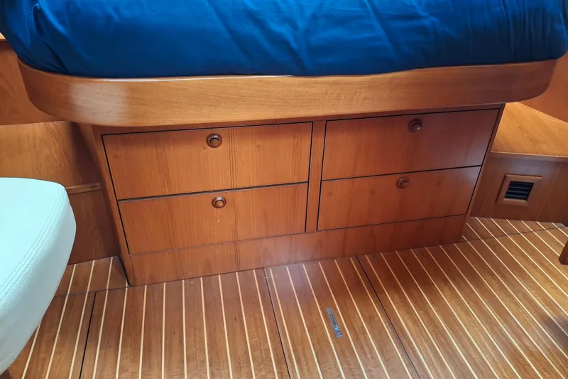 Slide: The Image of Wooden cabin drawers in a 2009 Jeanneau Sun Odyssey 54 DS yacht interior. - 15