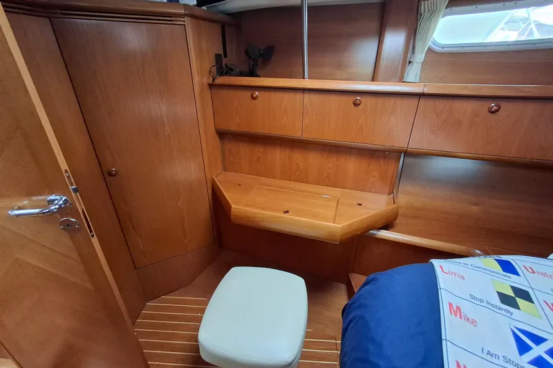 Slide: The Image of Cozy cabin interior of 2009 Jeanneau Sun Odyssey 54 DS with wooden furnishings. - 17