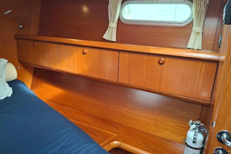 Slide: The Image of Interior cabin of 2009 Jeanneau Sun Odyssey 54 DS with wooden cabinetry and porthole window. - 18