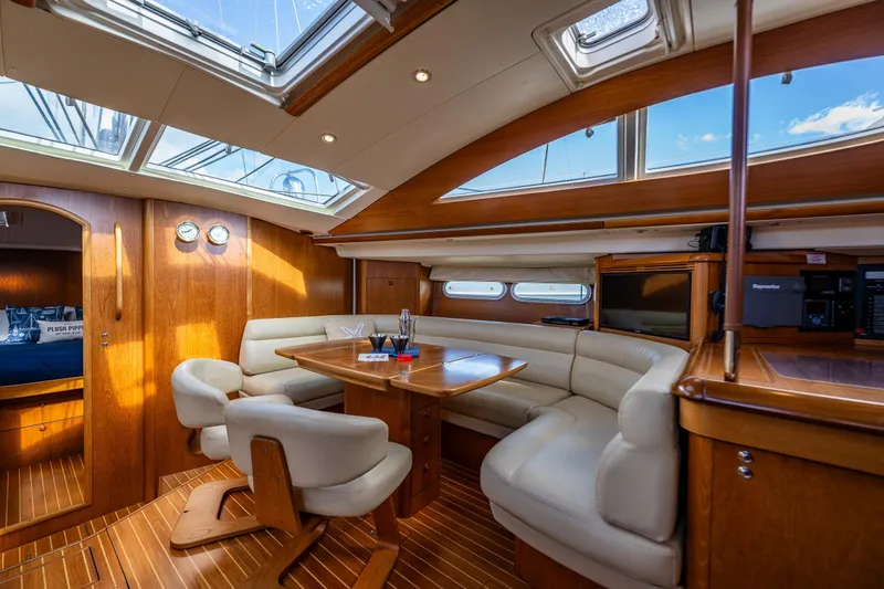 Slide: The Image of Interior cabin of 2009 Jeanneau Sun Odyssey 54 DS yacht, featuring wooden finishes and storage. - 26