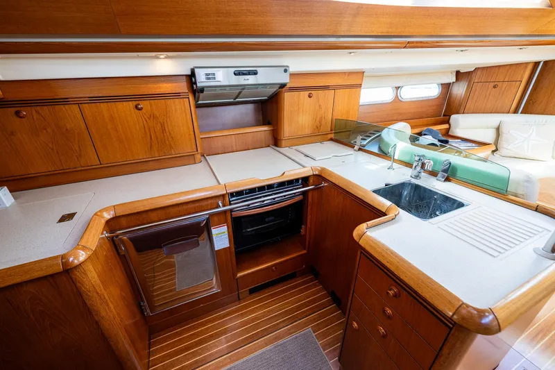 Slide: The Image of Cozy cabin interior of 2009 Jeanneau Sun Odyssey 54 DS yacht with blue bedding. - 32