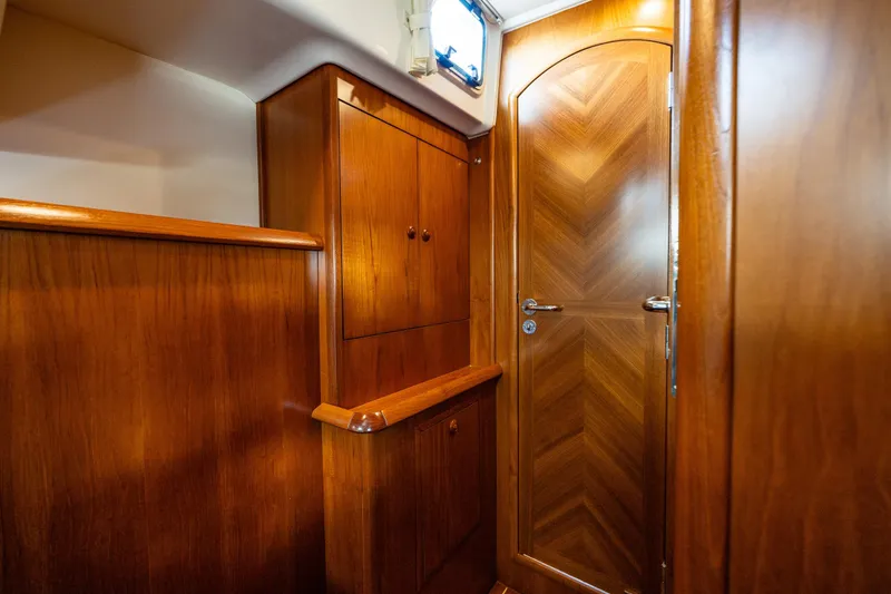 Slide: The Image of Luxurious cabin interior of 2009 Jeanneau Sun Odyssey 54 DS yacht with blue bedding. - 41