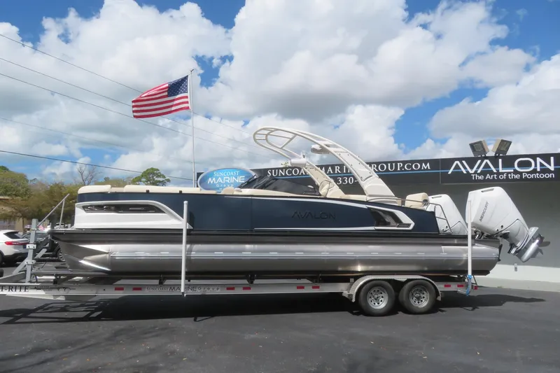 Slide: The Image of 2026 Avalon Excalibur LTD Quad Lounger pontoon boat on trailer. - 10