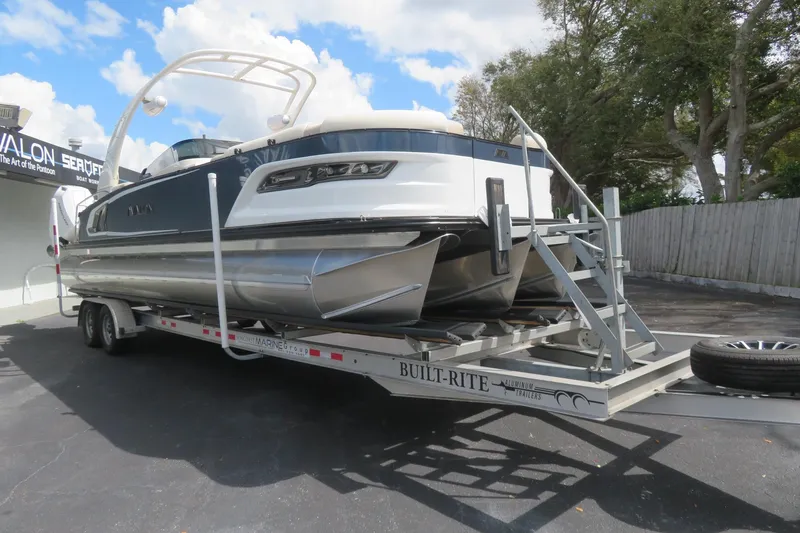 Slide: The Image of 2026 Avalon Excalibur LTD Quad Lounger on trailer, side view. - 17