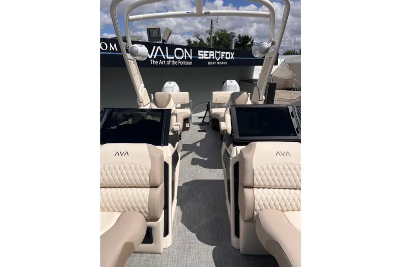 Slide: The Image of Luxurious Avalon pontoon boat with beige seating and modern features. - 3