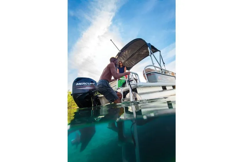 Slide: The Image of 2019 Sun Tracker Party Barge 18 DLX interior with beige seating and spacious layout. - 15