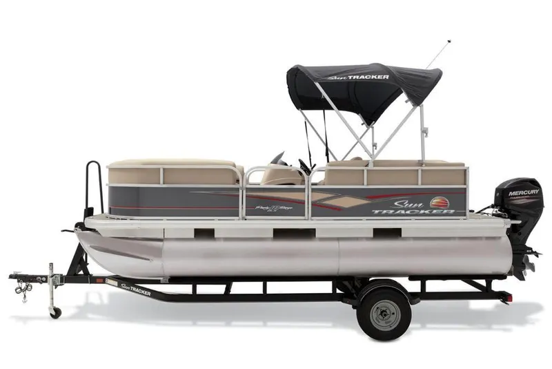 Slide: The Image of 2019 Sun Tracker Party Barge 18 DLX interior with beige seating and helm. - 18