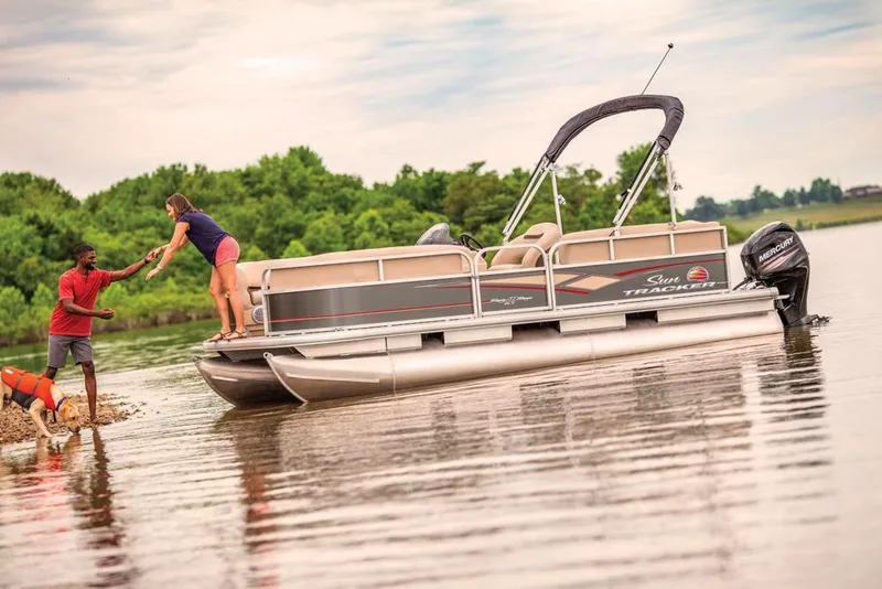 Slide: The Image of 2019 Sun Tracker Party Barge 18 DLX with Mercury outboard motor, parked outdoors. - 3
