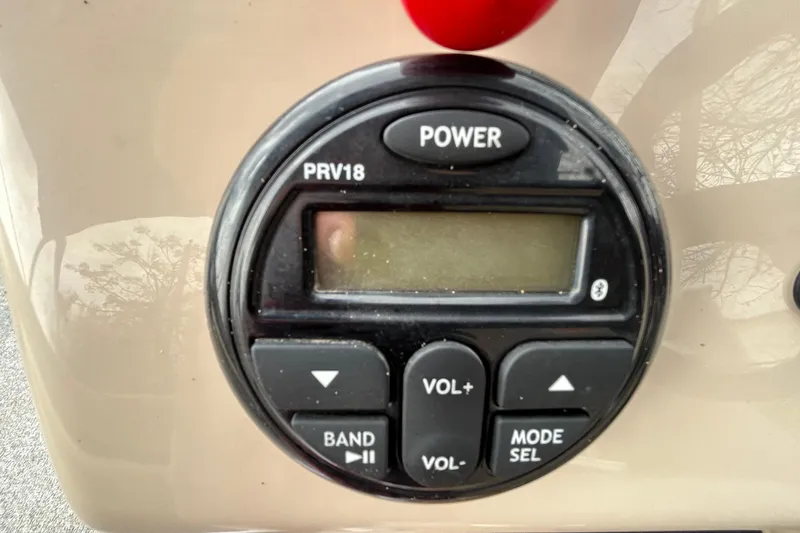 Slide: The Image of 2019 Sun Tracker Party Barge 18 DLX storage compartment with open seat cushion. - 32