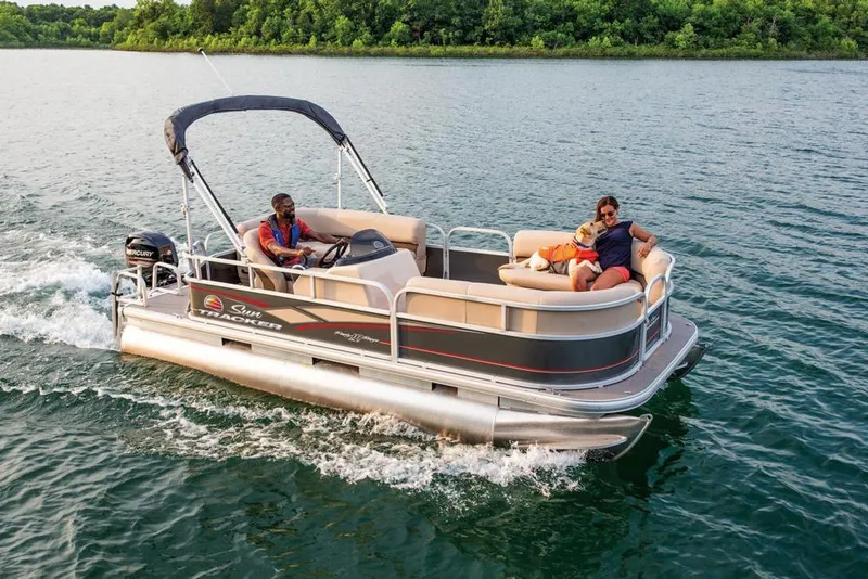 Slide: The Image of 2019 Sun Tracker Party Barge 18 DLX pontoon boat on trailer, parked outdoors. - 6