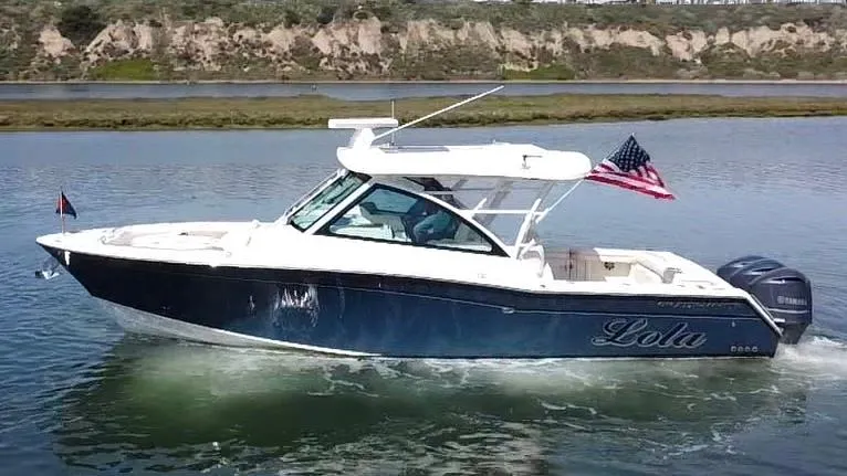 The Image of 2017 Grady-White Freedom 375 boat cruising on water with American flag. - 0
