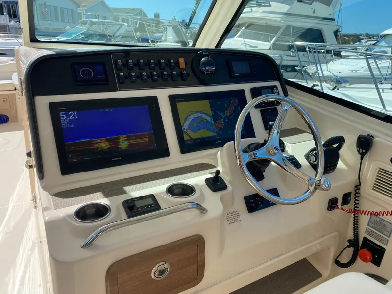 Slide: The Image of 2017 Grady-White Freedom 375 helm with dual displays and steering wheel. - 12