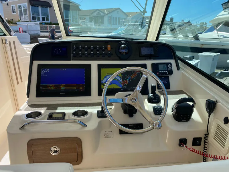 Slide: The Image of 2017 Grady-White Freedom 375 helm with navigation screens and steering wheel. - 14