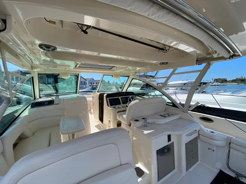 Slide: The Image of 2017 Grady-White Freedom 375 boat interior with helm, seating, and marina view. - 17