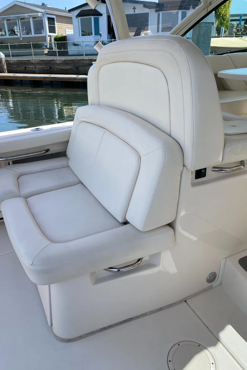 Slide: The Image of 2017 Grady-White Freedom 375 boat seat, white leather, dockside view. - 20