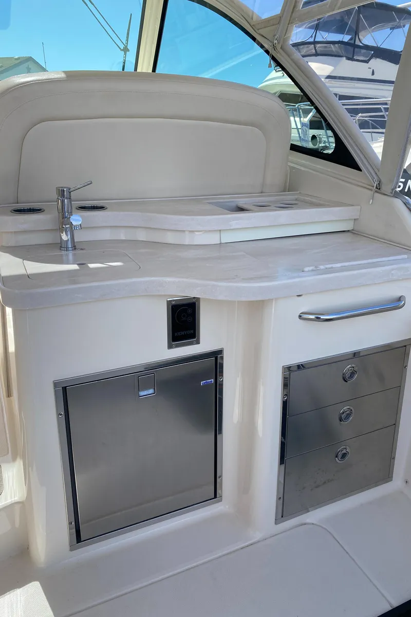 Slide: The Image of 2017 Grady-White Freedom 375 boat interior with kitchenette and storage. - 24