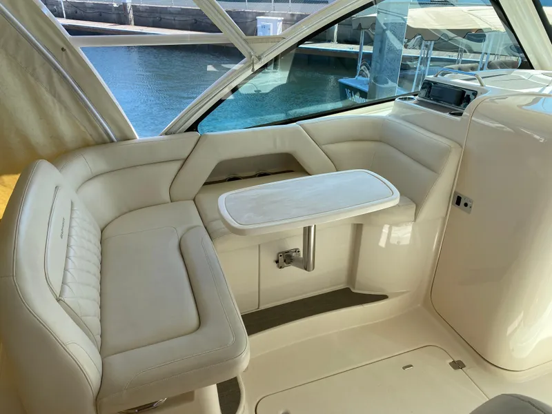 Slide: The Image of 2017 Grady-White Freedom 375 boat interior with cushioned seating and table. - 28