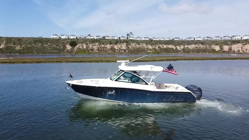 Slide: The Image of 2017 Grady-White Freedom 375 boat cruising on calm water with scenic background. - 3