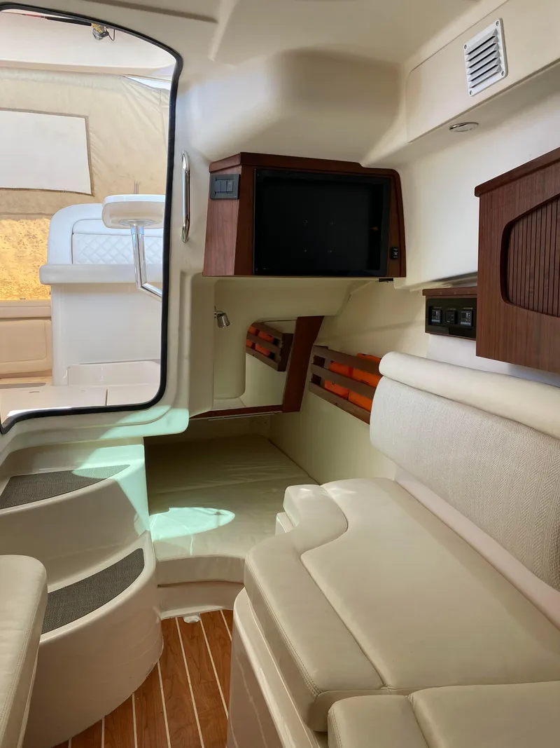 Slide: The Image of Interior of 2017 Grady-White Freedom 375 boat, featuring seating and wooden accents. - 33