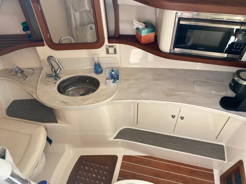 Slide: The Image of 2017 Grady-White Freedom 375 boat interior with kitchenette, sink, and microwave. - 34