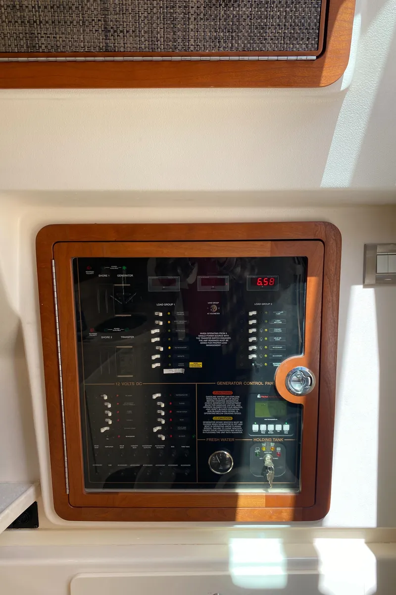 Slide: The Image of Control panel of a 2017 Grady-White Freedom 375 boat, featuring switches and gauges. - 36