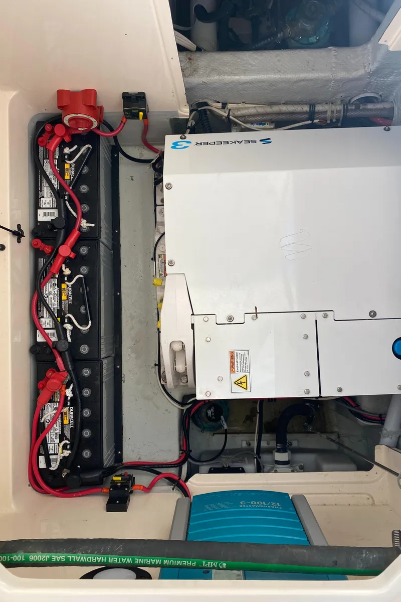 Slide: The Image of Engine compartment of a 2017 Grady-White Freedom 375 boat, showing battery setup and electrical components. - 38