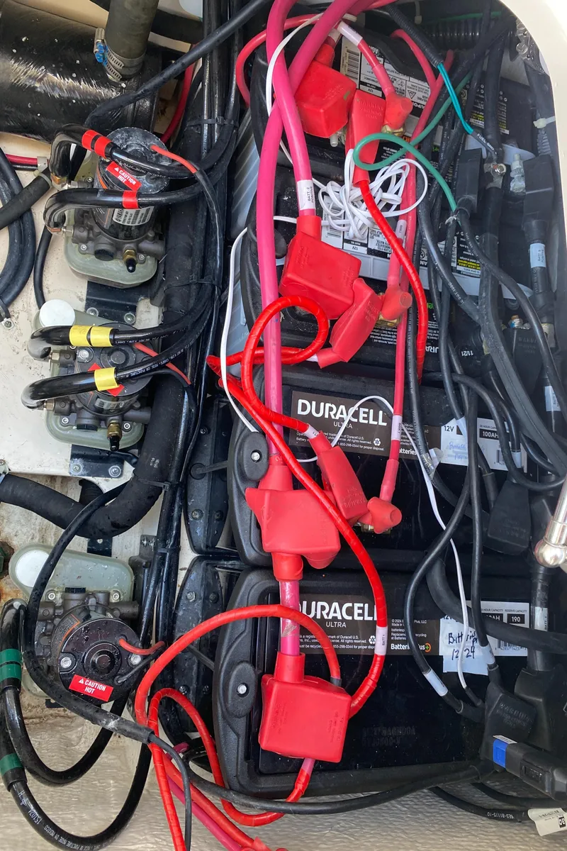Slide: The Image of Battery compartment of 2017 Grady-White Freedom 375 boat with Duracell batteries and wiring. - 42