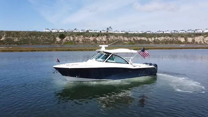 Slide: The Image of 2017 Grady-White Freedom 375 boat cruising on calm water with American flag. - 5