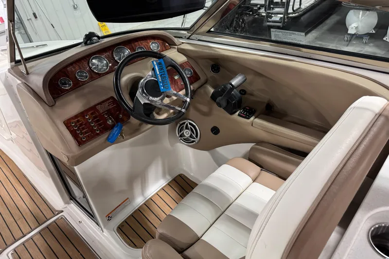 Slide: The Image of Interior of a 2007 Cobalt 282 boat with wood accents and beige seating. - 7