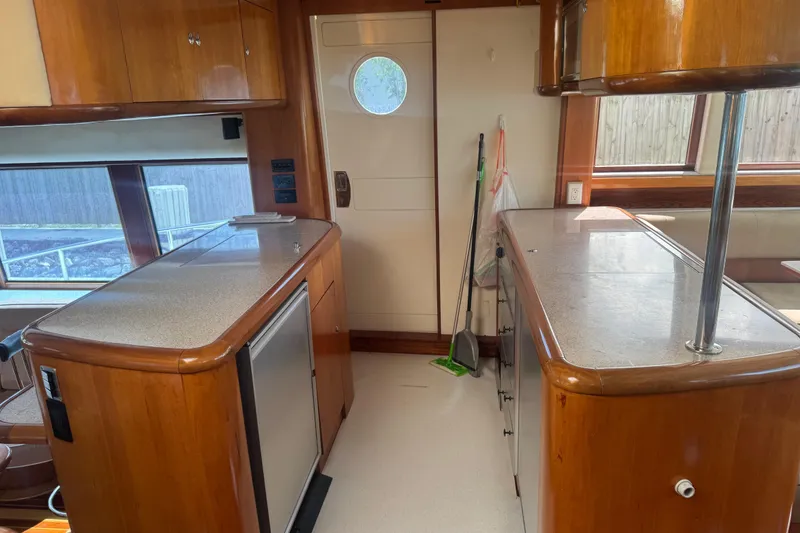 Slide: The Image of Interior of 2003 Custom Sea Star Pilot House with wooden cabinetry and countertops. - 12