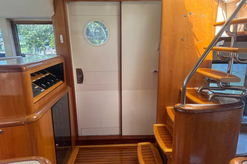 Slide: The Image of Interior of 2003 Custom Sea Star Pilot House with wooden stairs and control panel. - 13
