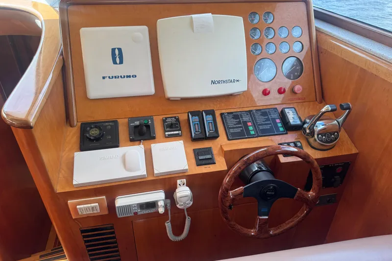 Slide: The Image of 2003 Custom Sea Star Pilot House dashboard with navigation and control instruments. - 15