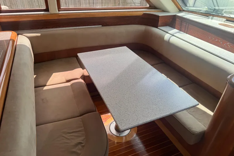 Slide: The Image of Interior of 2003 Custom Sea Star Pilot House with cozy seating and table. - 16