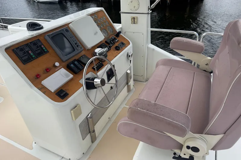 Slide: The Image of Pilot house of 2003 Custom Sea Star, featuring steering wheel and navigation controls. - 22