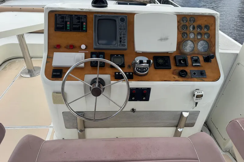 Slide: The Image of 2003 Custom Sea Star Pilot House helm with steering wheel and navigation controls. - 23