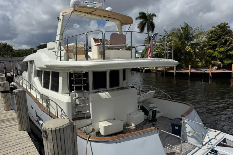 Slide: The Image of 2003 Custom Sea Star Pilot House yacht docked by palm trees and waterway. - 4